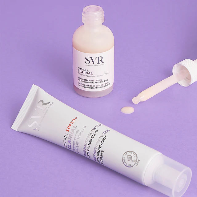 SVR Clairial ampoule with dropper and SPF50+ cream tube on a purple background.